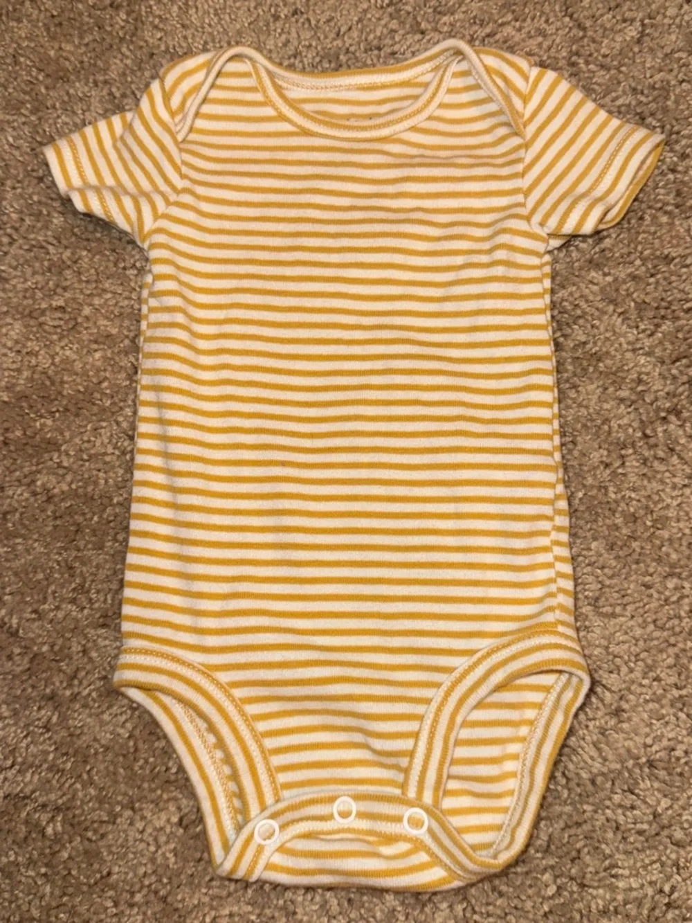 white and yellow striped baby onesies